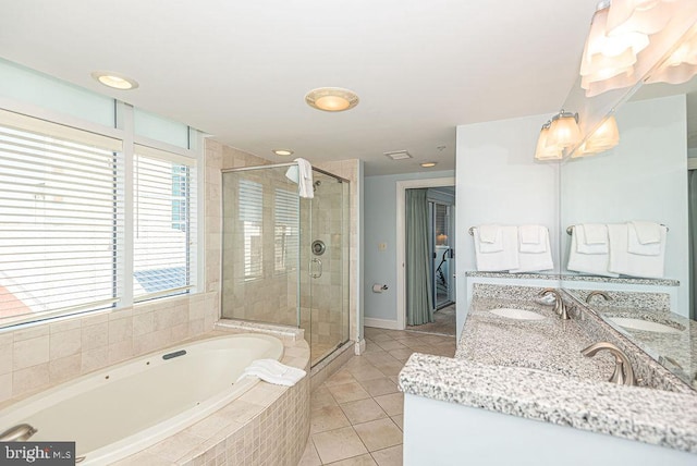 bathroom with tile patterned floors, vanity, and independent shower and bath