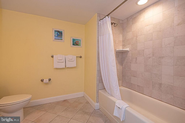 bathroom featuring tile patterned flooring, shower / tub combo, and toilet