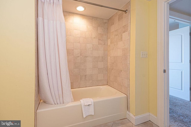 bathroom featuring tile patterned flooring and shower / bath combo