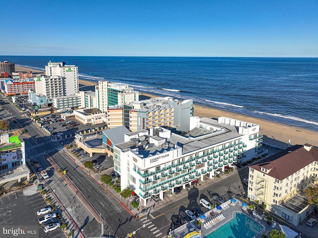 birds eye view of property with a water view and a view of the beach