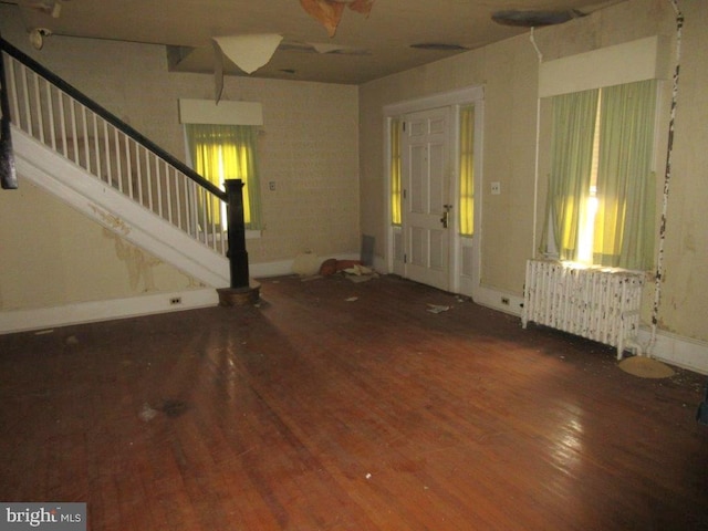 entryway featuring wood-type flooring and radiator heating unit