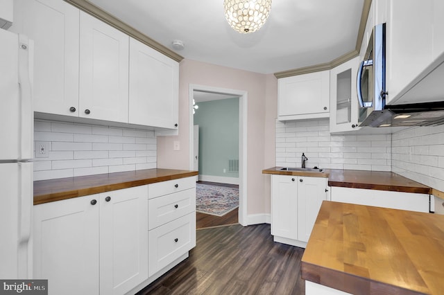 kitchen with dark hardwood / wood-style flooring, white cabinetry, and butcher block counters