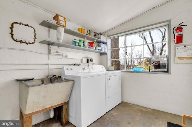 laundry room featuring washer and clothes dryer and sink