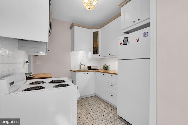 kitchen with white cabinets, wood counters, white appliances, and backsplash