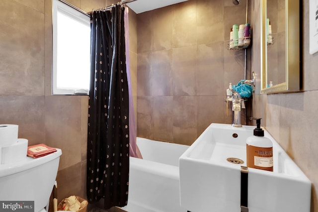 full bathroom featuring shower / tub combo, toilet, tile walls, and sink