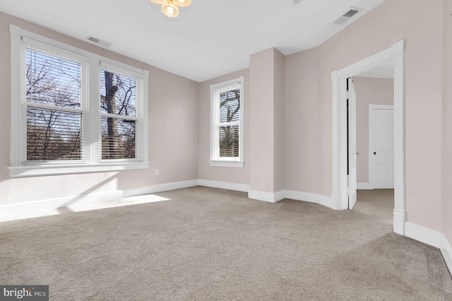 empty room featuring light colored carpet