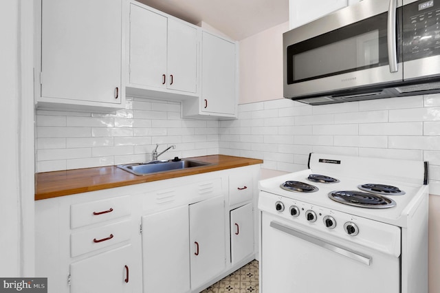 kitchen featuring tasteful backsplash, white range with electric cooktop, white cabinetry, and sink