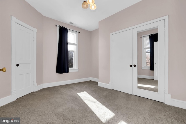 unfurnished bedroom featuring carpet flooring, a closet, and french doors