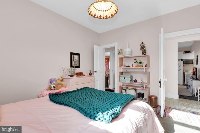 bedroom featuring carpet and white refrigerator