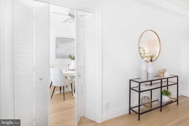 hallway featuring baseboards and wood finished floors