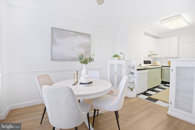 dining room with light wood finished floors and baseboards