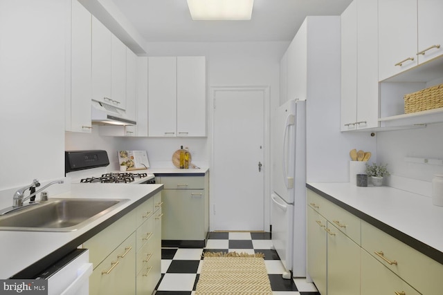 kitchen featuring under cabinet range hood, white appliances, a sink, light countertops, and tile patterned floors