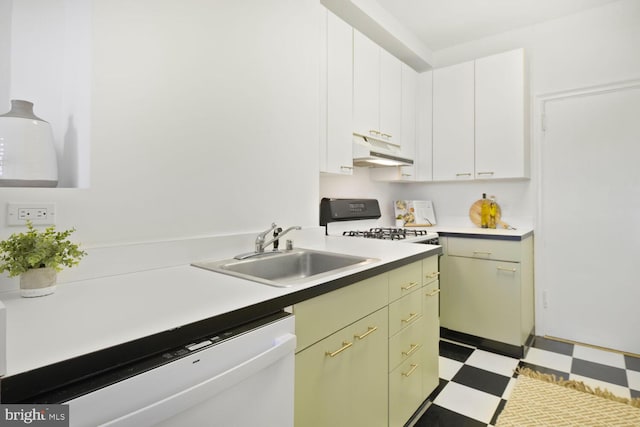 kitchen with light floors, light countertops, white dishwasher, a sink, and under cabinet range hood