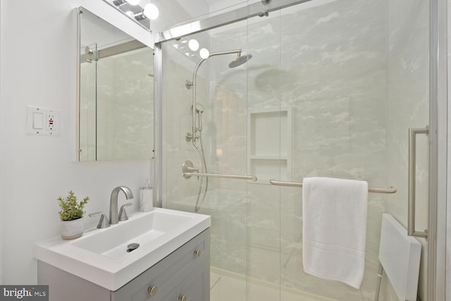 full bathroom featuring a stall shower and vanity