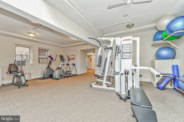 exercise room with ceiling fan and baseboards