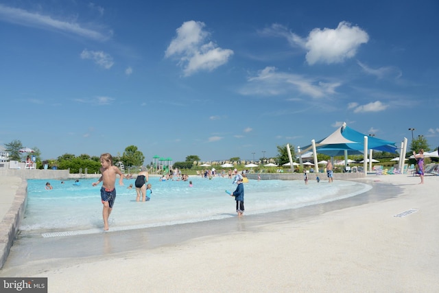 view of property's community with a beach view