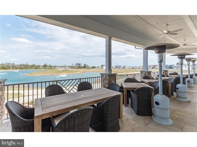 view of patio featuring a water view and ceiling fan