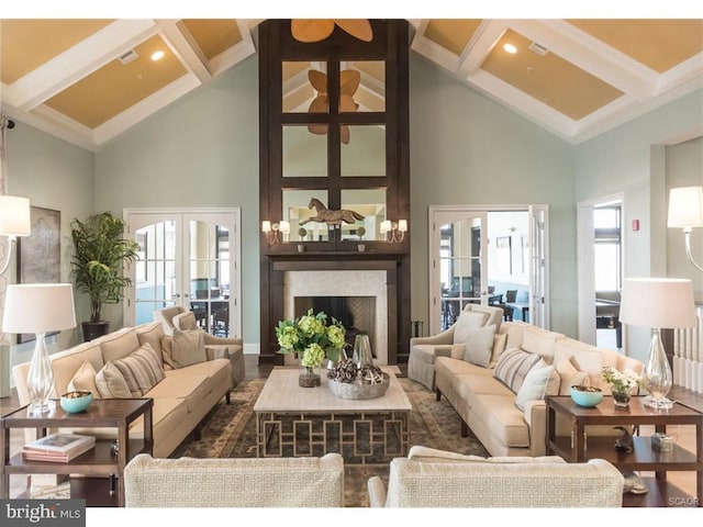 living room featuring a fireplace, french doors, high vaulted ceiling, and a healthy amount of sunlight