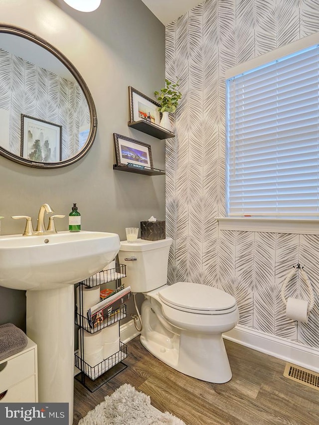 bathroom featuring hardwood / wood-style flooring and toilet