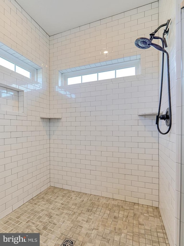 bathroom with a tile shower