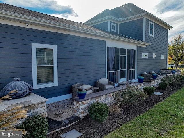 back of house with a sunroom and a patio area