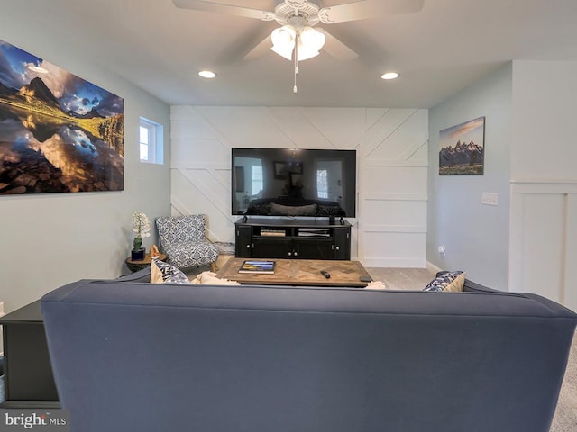 living room with carpet and ceiling fan