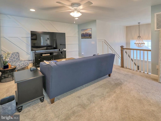 carpeted living room with ceiling fan