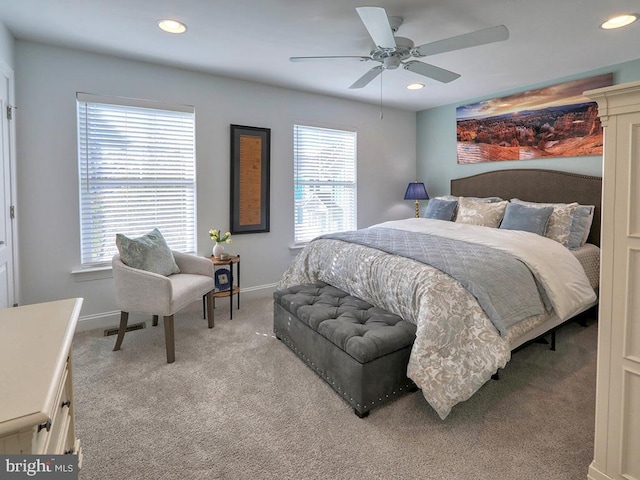 carpeted bedroom with multiple windows and ceiling fan