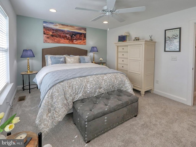 bedroom with ceiling fan and light carpet