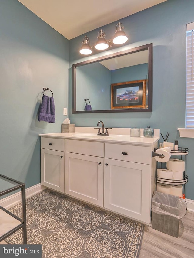 bathroom with hardwood / wood-style floors and vanity