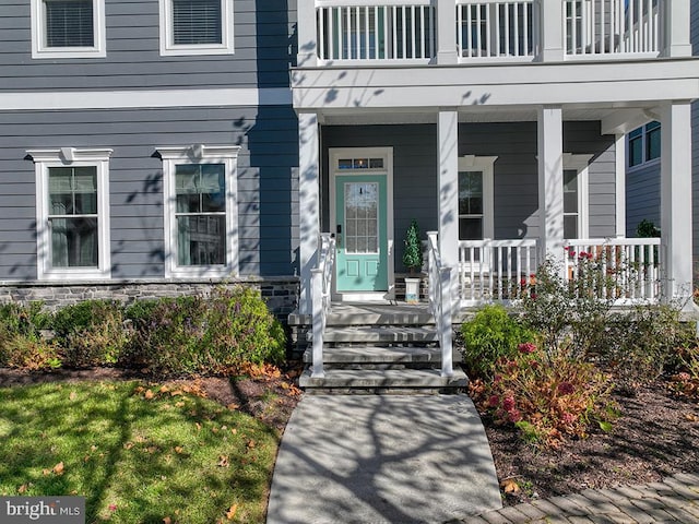 view of exterior entry featuring covered porch