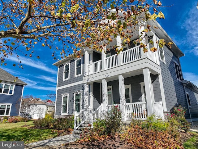 view of front facade with a balcony and a porch