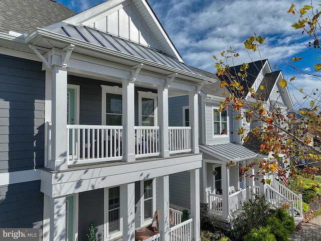 view of property exterior with a balcony and a porch