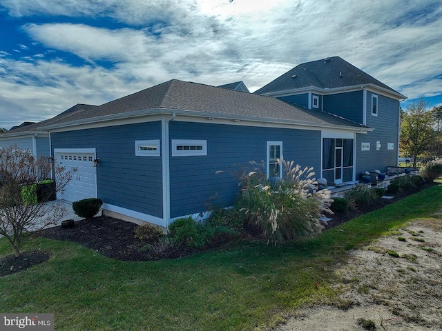 view of property exterior with a garage and a yard