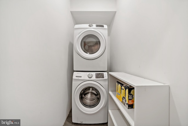 washroom featuring stacked washer and clothes dryer