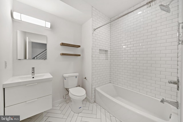 full bathroom with tile patterned floors, toilet, vanity, and tiled shower / bath