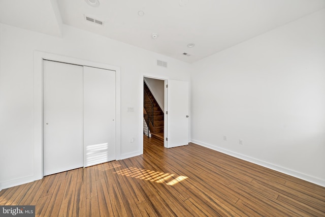 unfurnished bedroom with a closet and wood-type flooring