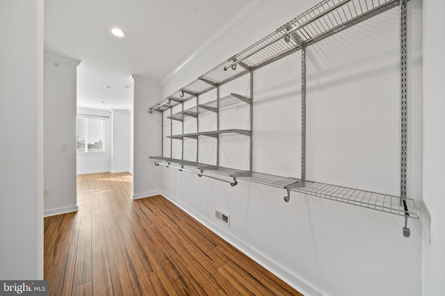 spacious closet with hardwood / wood-style flooring