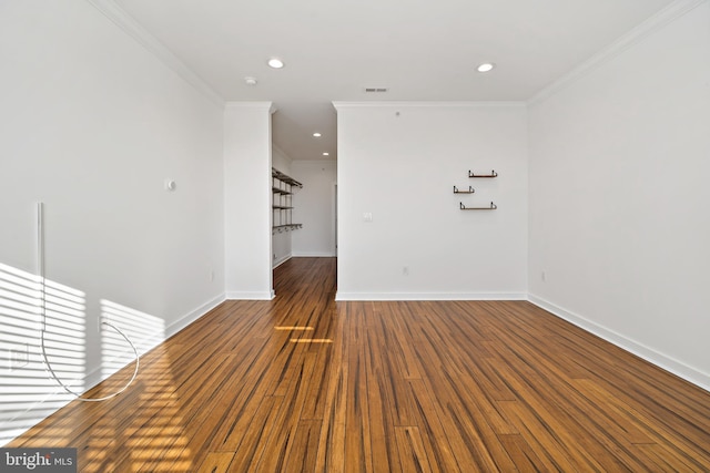 spare room with ornamental molding and dark wood-type flooring