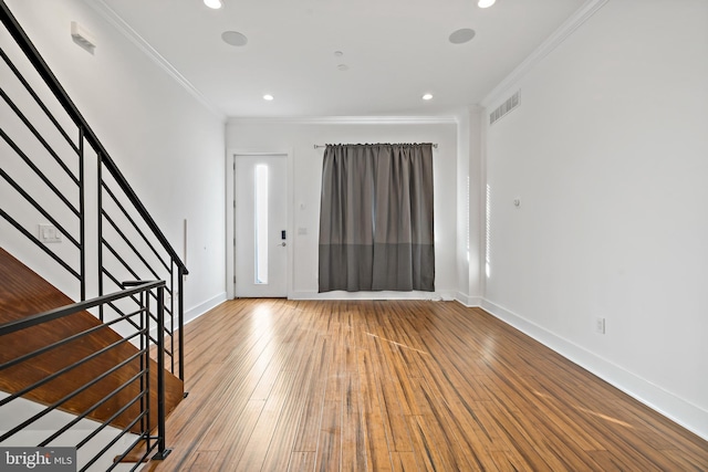 entrance foyer featuring hardwood / wood-style floors and ornamental molding