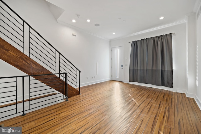 interior space with crown molding and hardwood / wood-style flooring