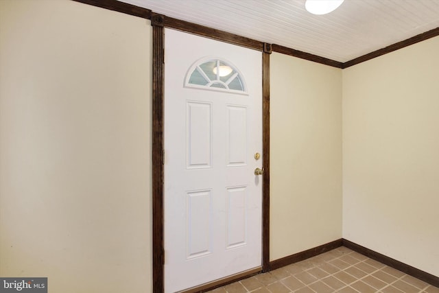 tiled foyer entrance with ornamental molding