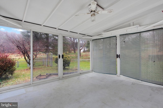 unfurnished sunroom featuring ceiling fan and vaulted ceiling