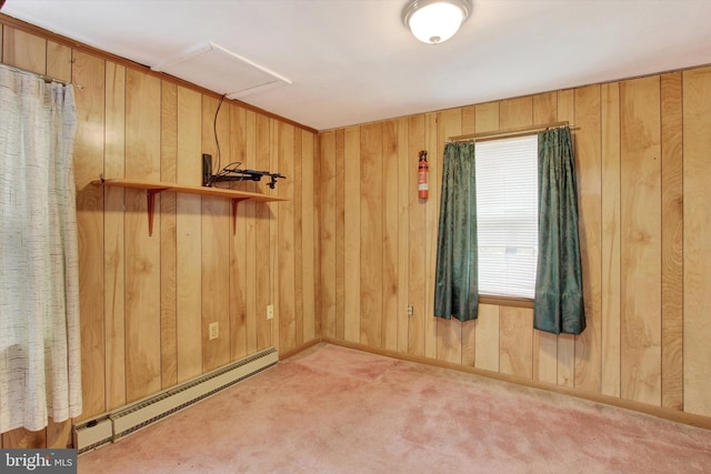 unfurnished room with carpet flooring, wood walls, and a baseboard radiator