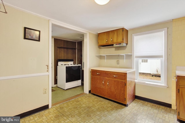 kitchen with white stove and wooden walls