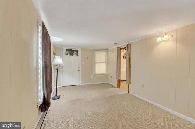 unfurnished room featuring crown molding, light carpet, and a chandelier