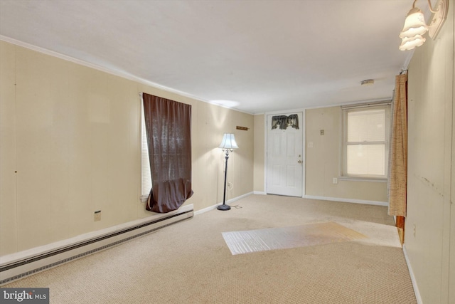 carpeted empty room featuring crown molding and a baseboard radiator