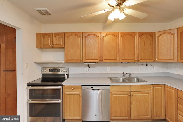 kitchen with appliances with stainless steel finishes, ceiling fan, and sink