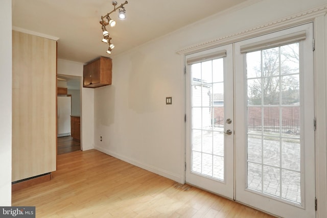 entryway with french doors, light hardwood / wood-style floors, and ornamental molding