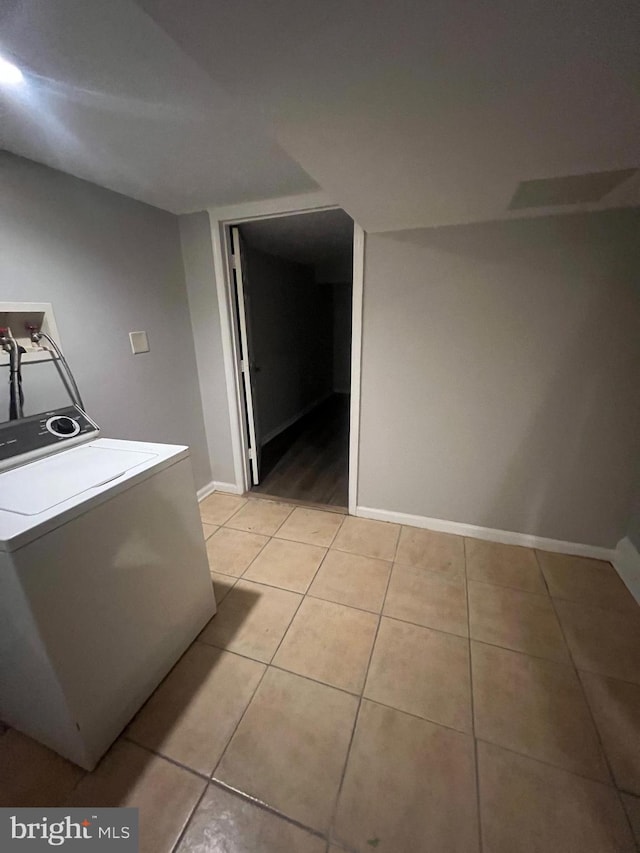 laundry room with light tile patterned flooring and washer / clothes dryer